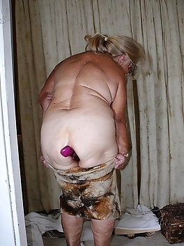 Elderly blonde with pigtails exposes her hairy mound & masturbates in the kitchen